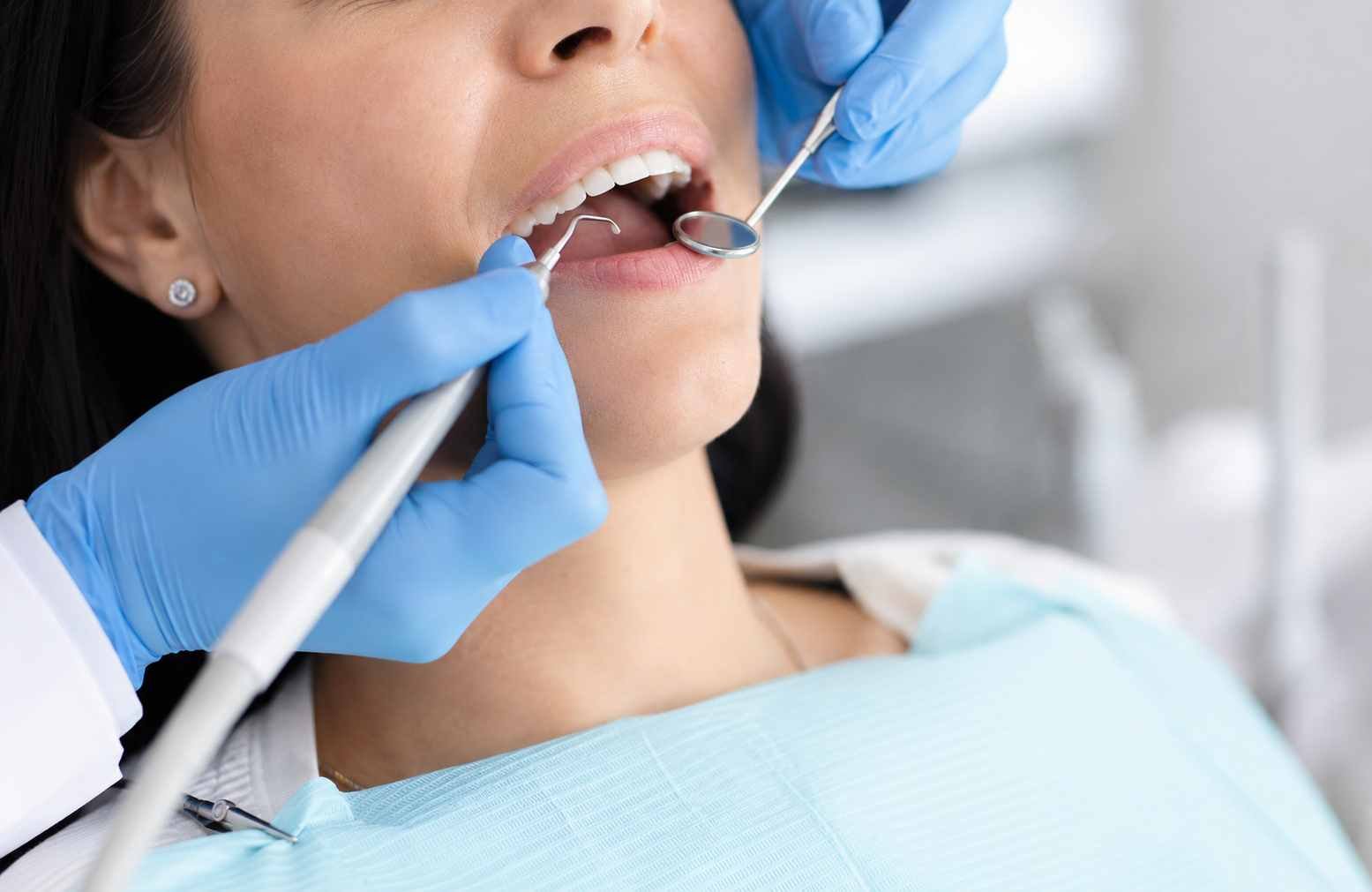 Gentle dental hygienist performing ultrasonic teeth scaling in Bradford