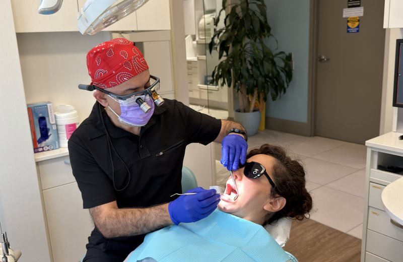 Dentist performing dental bonding treatment at Hola Dentistry in Bradford