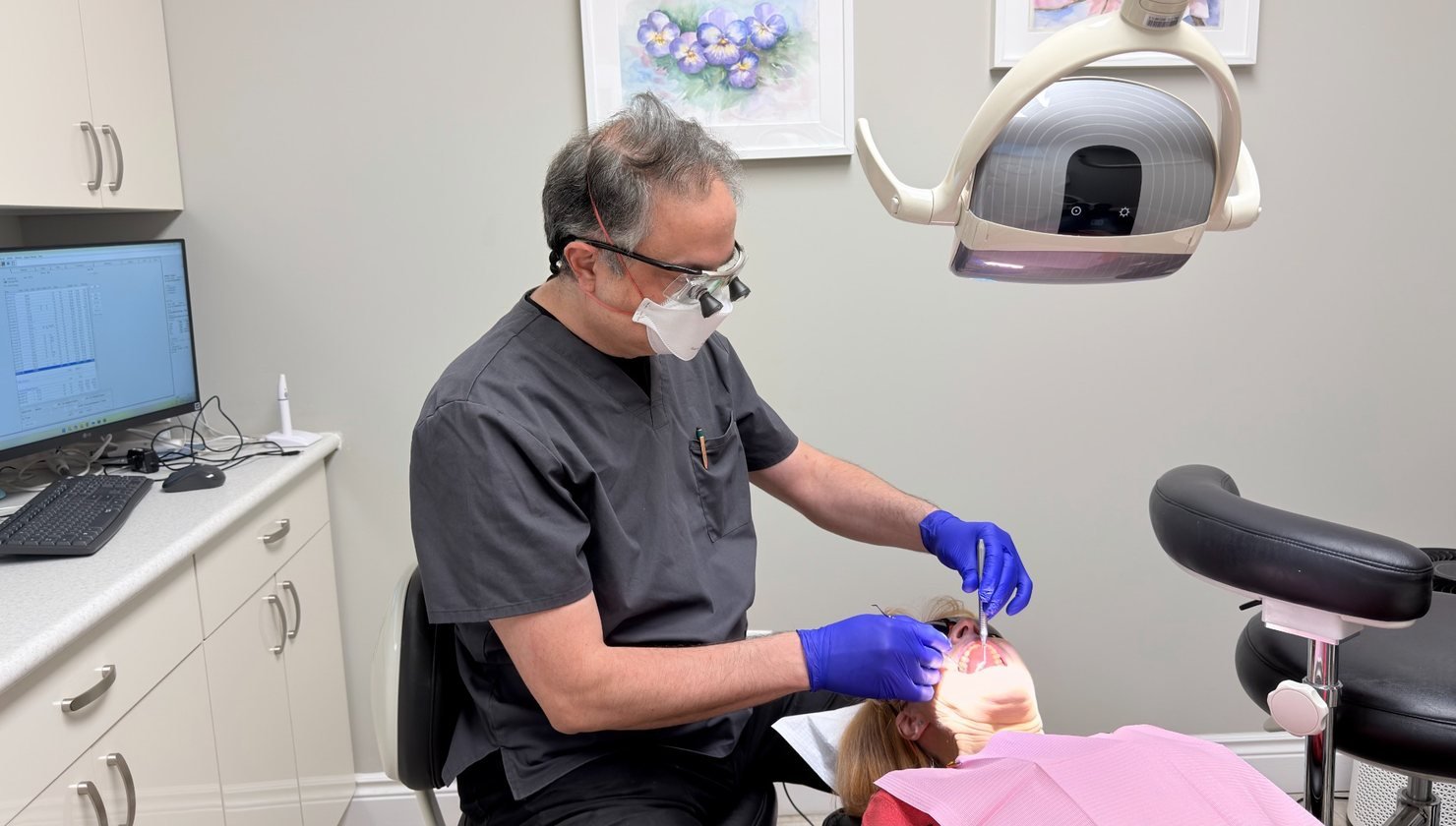 Dentist providing wisdom teeth treatment at Hola Dentistry in Bradford