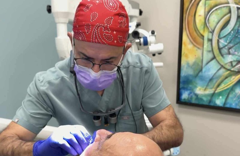 Dentist providing dentures treatment at Hola Dentistry in Bradford