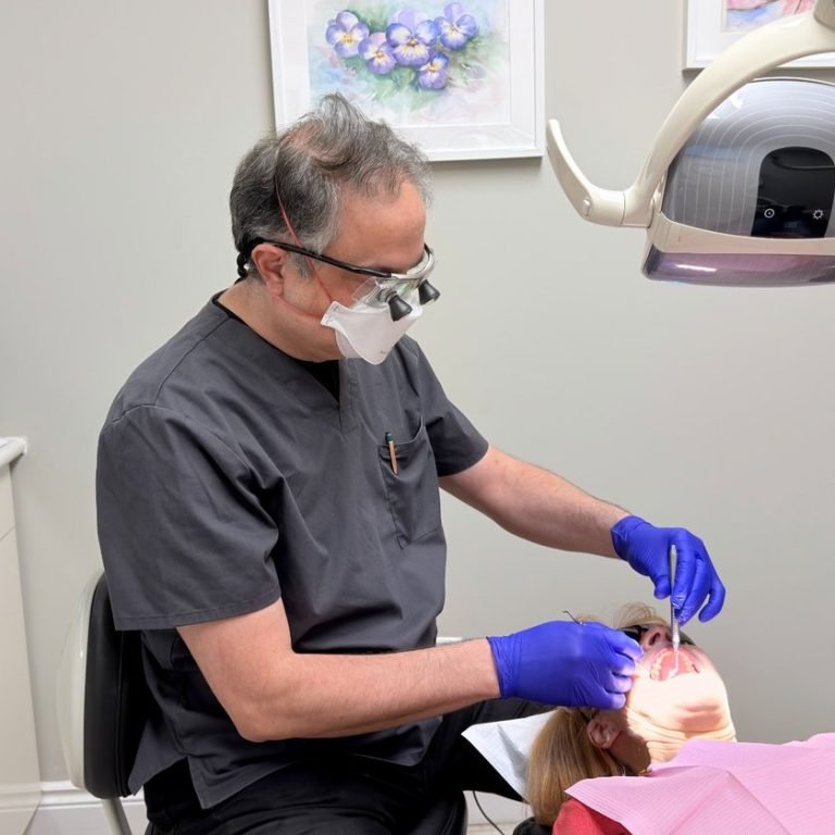 Dentist providing wisdom teeth treatment at Hola Dentistry in Bradford